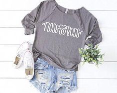 a shirt that says floss to boss on it next to ripped shorts and sneakers