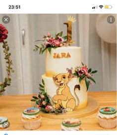 a birthday cake and cupcakes on a table