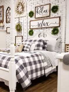 a white bed with black and white checkered comforter in a room decorated for christmas