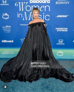 lady in black at the billboard awards wearing an off - shoulder gown and high heels