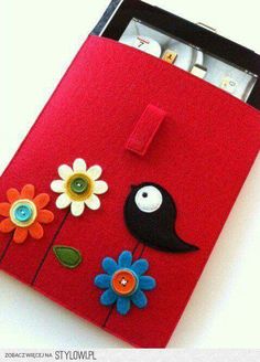 a red case with flowers and a bird on the front is made out of felt