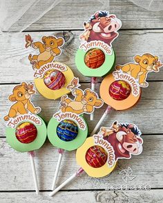 the lollipops are decorated with animals and name stickers on top of them