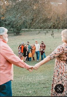 a group of people holding hands in the grass