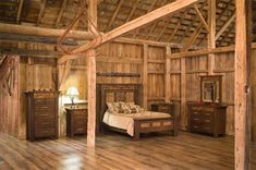 a rustic bedroom with wooden floors and walls