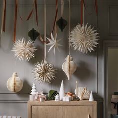 christmas decorations are hanging on the wall above a buffet with candles and ornaments in it