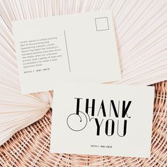 two thank you cards sitting on top of a wicker basket next to each other