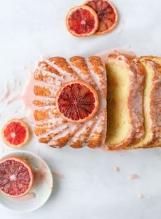 slices of orange cake with icing and blood oranges