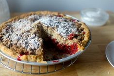 a pie on a cooling rack with one slice cut out and ready to be eaten