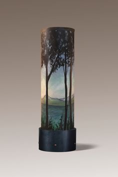 a vase with trees painted on it