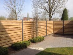 a wooden fence in the middle of a yard