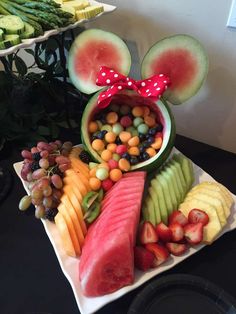 a mickey mouse head made out of watermelon, apples, grapes and melons