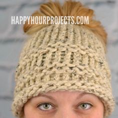 a woman wearing a knitted hat with pompom