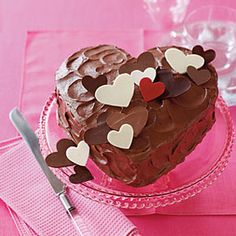 a heart shaped cake on a plate with hearts cut out of it and the words valentine's day cupcake