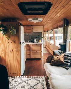 the interior of an rv with wood paneling on the walls and ceiling is clean