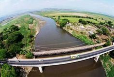 an aerial view of a bridge over a river