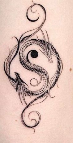 a black and white tattoo design on the back of a woman's stomach