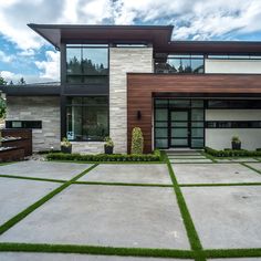 a large modern house with grass in front