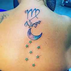 the back of a woman's upper back tattoo with stars and moon on it