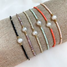 "Add a little Boho Chic to your everyday look with our latest pearl accent beaded bracelets.  Pair them with other bead bracelets, your favorite gold or silver bracelets, or even your watch for the stack of the season. Details:  Miyuki Glass Beads, Freshwater Pearl, Nylon Cord Bracelets expand from 6\" to 10\" A little bit about us: Mom-owned Business Sourcing only the highest quality materials Quick shipping from Colorado" Beaded Bracelet With Pearl Charm As Gift, Adjustable Pearl Bracelet With Colorful Beads, Adjustable Pearl Bracelet With Letter Beads, Gift Beaded Bracelet With Pearl Charm, Minimalist Beaded Pearl Bracelet As Gift, Adjustable Dainty Pearl Bracelet With Spacer Beads, Dainty Pearl Beaded Bracelets With Spacer Beads, Dainty Adjustable Pearl Bracelet With Spacer Beads, Dainty Pearl Beaded Bracelet With Spacer Beads