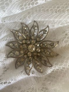 A very old vintage brooch with rhinestones!  A beautiful piece! All there and in pretty good shape! This was from my Grandmothers collection!  Maybe from the 50s or 60s Vintage Rhinestone Brooches For Vintage Events, Vintage Rhinestone Brooches For Party, Vintage Rhinestone Party Brooches, Vintage Rhinestone Brooches For Evening, Vintage Evening Brooches With Rhinestones, Retro Wedding Brooches With Rhinestones, Vintage Rhinestone Brooches For Anniversary, Vintage Flower Brooch For Evening, Vintage Rhinestone Pins For Party