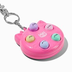 a key chain with an animal shaped object attached to it's front end and four different colored balls in the shape of a cat