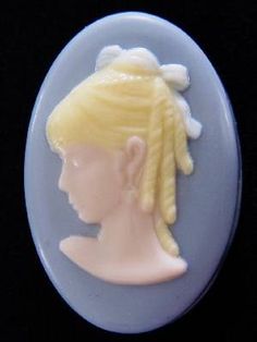 a button with a woman's head on it