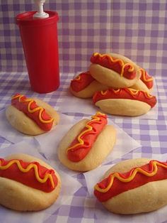 six hotdogs with mustard and ketchup on them