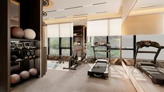 an exercise room is shown with treadmills, machines and yoga balls on the floor