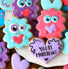 some decorated cookies are on a plate with the words you're monstrous