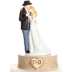 a wedding cake topper with a bride and groom on it