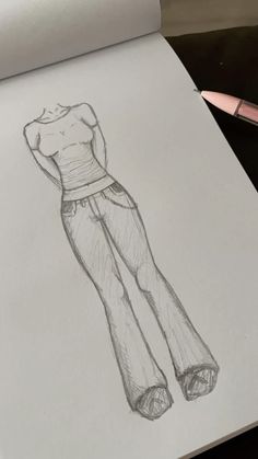 a drawing of a woman's top and pants in pencil on a piece of paper