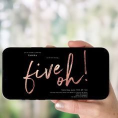 a person holding up a phone with the words five oh written in pink on it