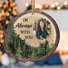 a christmas ornament hanging from a tree with the words i'm always with you