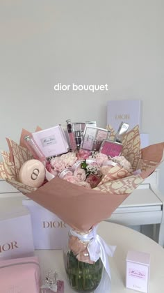 a bouquet of flowers sitting on top of a table next to some cards and other items