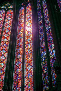 the sun shines brightly through stained glass windows in sainte - michel's cathedral