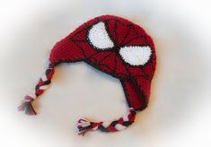 a crocheted spiderman hat with red and white stripes