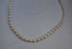 Beautiful white freshwater baroque pearl necklace nicely matched in color and size the pearls measure 7.4 mm diameter by 8 mm long (average) the clasp is sterling and marked 925 Elegant White Baroque Necklace, Baroque Pearl White Necklaces, Handmade White Baroque Necklaces, Classic Baroque Pearl Necklace With High Luster, Baroque Pearl White Briolette Pearl Necklace, High Luster Baroque Pearl Classic Necklace, White Baroque Pearl Single Strand Necklace, Classic Pear-shaped Baroque Pearl Necklace, Baroque Pearl Necklace