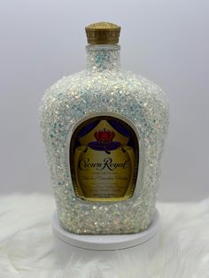 a bottle that has some kind of liquid inside of it on a white fur surface