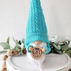 a gnome with a blue knitted hat on top of a white table