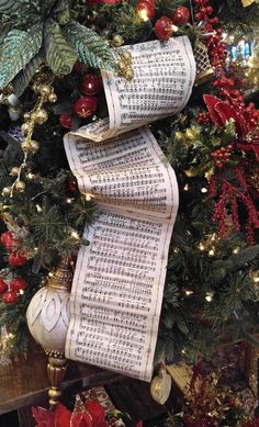 the christmas tree is decorated with sheet music