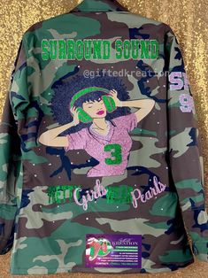 a camo jacket with an image of a woman wearing headphones on the back