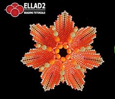 an orange and white beaded flower on a black background with the words ellad2 below it