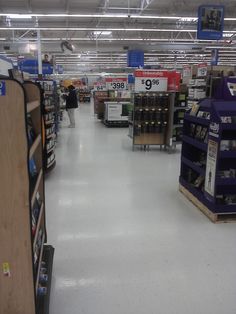 an aisle in a store filled with lots of shelves and boxes on the floor next to each other