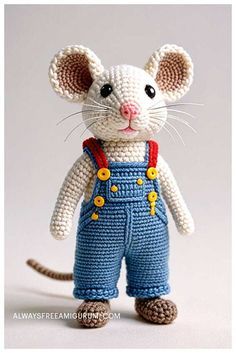 a small crocheted mouse wearing overalls