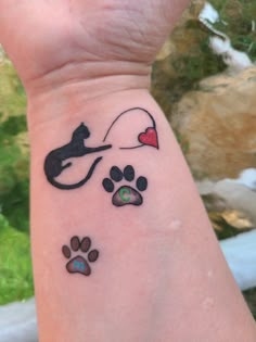 a cat and dog paw tattoos on the wrist