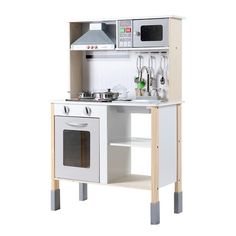 a white wooden play kitchen set with an oven and microwave on the top shelf next to it