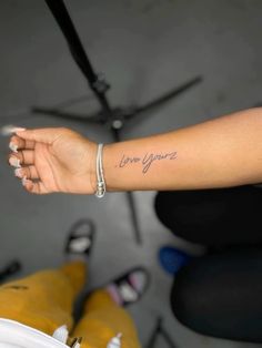 a woman's arm with the word love you written in cursive font