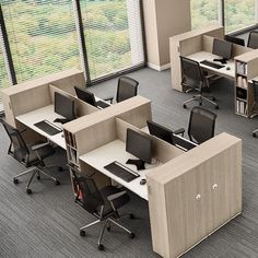 an office cubicle with multiple desks and chairs