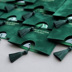 many green graduation caps with tassels are on a white surface and there is no image here to provide a caption for