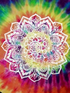 a colorful tie - dyed t - shirt with an image of a flower on it